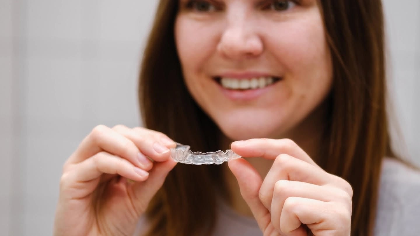 A person holding an invisalign